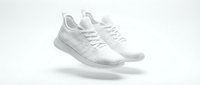 White knit sneakers floating on a light background, showcasing modern athletic footwear design for fashion and sport lifestyle concepts.