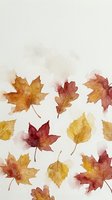 Watercolor autumn leaves in warm orange, red and yellow tones scattered on textured paper background for seasonal design projects.