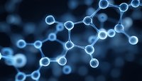 Glowing blue molecular structure on dark background shows connected atoms forming chemical bonds in scientific visualization of molecular compounds.