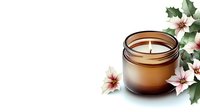 Aromatic soy candle in amber glass jar decorated with pink poinsettia flowers and holly leaves on white background, creating cozy holiday atmosphere.