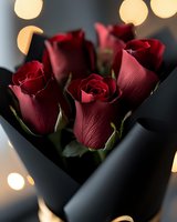 Deep red roses wrapped in black paper with soft bokeh lights in background, romantic Valentine's Day or anniversary gift composition.
