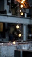 Industrial metalworking sparks flying from grinding or welding operation in modern factory workshop with bright glowing particles and machinery background.