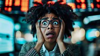 Young African American woman with natural curly hair and glasses expressing shock and surprise against blurred urban night lights and neon signs background.