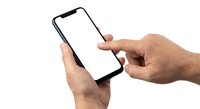 Male hands holding modern smartphone with blank white screen isolated on white background for mobile app mockup and digital technology presentation.