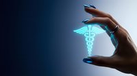 Hand holding glowing caduceus medical symbol with blue neon light effect against dark background for healthcare and medicine concepts.