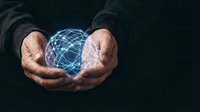 Male hands holding glowing digital globe network sphere on dark background, representing global connectivity, technology innovation, and worldwide business communication solutions.