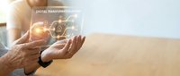 Senior hands holding glowing digital transformation icons with network connections representing modern technology adoption and business innovation.
