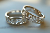 Elegant gold wedding rings with intricate leaf pattern cutouts symbolizing eternal love and commitment for couples celebrating marriage ceremony.