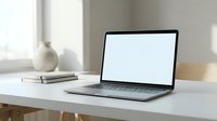 Modern laptop with blank white screen on minimalist white desk in bright home office workspace for mockup and design presentations.