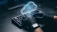 Hands typing on keyboard with glowing cloud computing hologram for digital technology and data storage solutions in modern workspace environment.