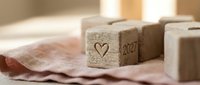 Wooden blocks with heart and 2027 symbol on fabric surface for New Year planning and goal setting projects.