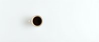 Top view of black coffee cup on white background for morning beverage and cafe concepts.