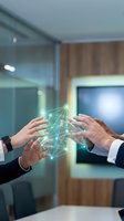 Business professionals collaborating with holographic network connections in modern office environment for teamwork and digital transformation concepts.