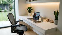 Organized home office workspace with white desk, black ergonomic chair, laptop, potted plants, and natural light from garden window for remote work and productivity.