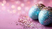 Festive blue Easter eggs decorated with colorful sprinkles on pink background with bokeh lights. Holiday celebration concept with copy space for text.