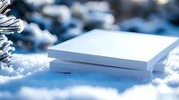 White blank book lying on snow in winter landscape with blurred snowy background for mockup and design projects.