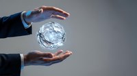 Business professional hands protecting glowing crystal sphere representing innovation, technology solutions, data security and corporate responsibility.