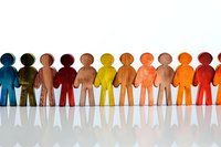 Colorful wooden figures standing in row symbolizing diversity, teamwork and social unity. Perfect for business presentations, HR concepts and inclusion campaigns.