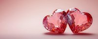 Two sparkling pink crystal hearts side by side on reflective surface against soft rose background, romantic symbol of love and affection for Valentine's Day designs.