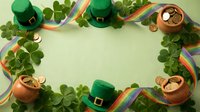 Lucky charms and festive decorations arranged in a circular frame with shamrocks, leprechaun hats, gold coins, and rainbow ribbons on pale green background for holiday celebrations.