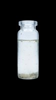Clear glass laboratory vial with screw cap containing liquid and sediment, isolated on transparent background. Ready for scientific, medical, educational design use, clipart, and print-on-demand applications.