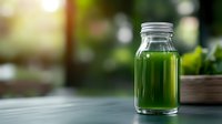 Fresh green smoothie or juice in glass bottle on wooden table with natural blurred background, healthy detox drink for wellness and diet lifestyle.