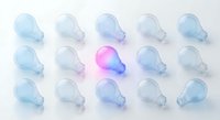 Glowing pink light bulb standing out among blue ones on white background, symbolizing unique idea, creativity, and leadership concept.