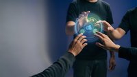 Business team collaborating with digital holographic globe showing global network connections and data visualization in modern office environment.
