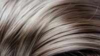 Flowing blonde hair strands with natural highlights and lowlights creating smooth waves and texture for beauty and haircare concepts.