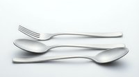 Modern stainless steel cutlery set with fork, knife and spoon on white background. Elegant flatware utensils for dining and kitchen use.