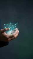 Hand holding glowing digital network mesh with connected nodes and lines on dark background, representing technology, data connection, and innovation for business solutions.