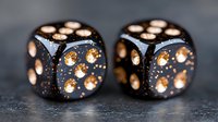 Black gaming dice with copper metallic dots on dark textured background, macro photography showing fine details and reflective surfaces for casino and gambling concepts.