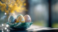 Decorative pastel Easter eggs in turquoise ceramic bowl on windowsill with soft natural light and golden bokeh background creating spring atmosphere.
