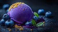 Purple blueberry ice cream scoop with fresh berries, mint leaves and cookie crumbs on dark background, selective focus with melting texture.