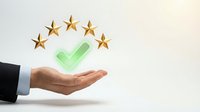 Business hand presenting green checkmark with five golden stars above representing quality service excellence and customer satisfaction rating concept.
