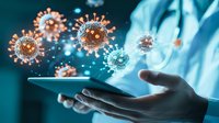 Medical professional in protective gear holding digital tablet with floating virus cell models, glowing orange and blue visualization for healthcare technology.