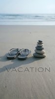 Flip flops and stacked zen stones on sandy beach with vacation text, ocean waves in background, summer holiday relaxation concept.