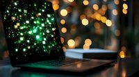 Laptop screen displaying green digital particles with bokeh lights background, modern technology concept for digital transformation and data analysis.