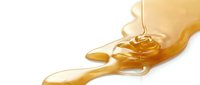 Honey dripping from wooden dipper onto white surface, isolated ingredient for cooking, baking, and food styling projects.