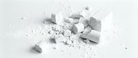 Crushed white chalk pieces and powder scattered on light surface, suitable for art education, creative projects, and design backgrounds.