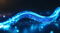 Glowing blue wave of particles with bokeh light effects on dark background creates magical flowing energy stream effect for technology designs.