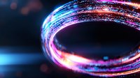 Glowing neon light trail in circular motion against dark background creates dynamic energy effect with blue and pink luminous streaks for technology designs.