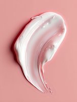 White creamy cosmetic texture smear on pink background, moisturizer or skincare product sample showing smooth glossy consistency for beauty industry.