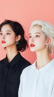 Two young Asian women with contrasting black and blonde hair wearing professional shirts against coral pink background for fashion and beauty concepts.