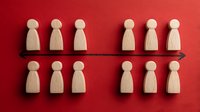 Wooden figurines arranged in two rows on red background, symbolizing team organization, business hierarchy, or social division concept.