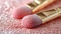 Luxury makeup brushes with soft pink bristles on rose gold glittery background for beauty and cosmetics applications.