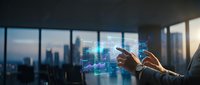 Businessman using holographic digital interface technology in modern office with city skyline view for data analysis and business management solutions.