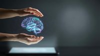 Human hands protecting glowing digital brain hologram representing mental health care, artificial intelligence, neuroscience and cognitive protection concepts.