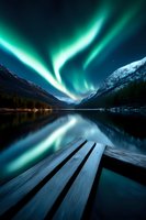 Spectacular aurora borealis dancing over snowy mountain peaks reflects in calm lake water, wooden pier extends into foreground creating dramatic perspective.