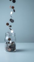 Coins falling into glass jar on neutral background representing savings, investment and financial planning concepts for business presentations.